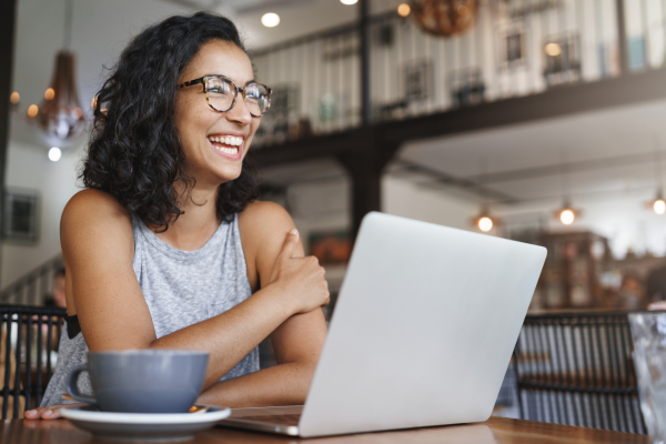 Wealth and well-being webinar Girl smiling with computer