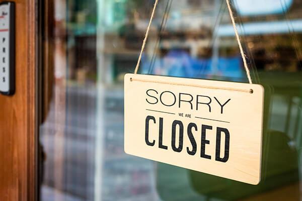 Closed sign hanging on business